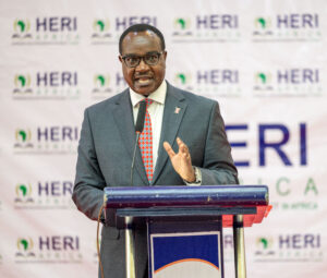 Education CS Hon Julius Ogamba speaking at the event as he launches HERI Africas National Education Research Agenda (NERA) at Kisii University (right)